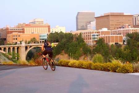 cyclist on centennial trail - kendall yards-1